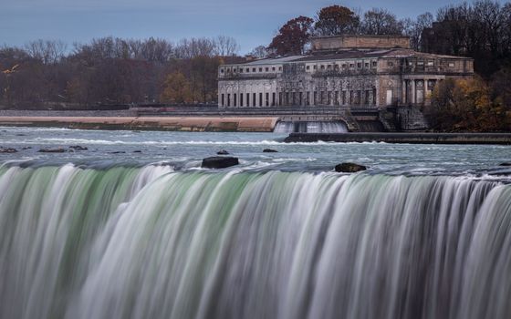 A majestic waterfall cascades near a historic power station at Niagara Falls.
