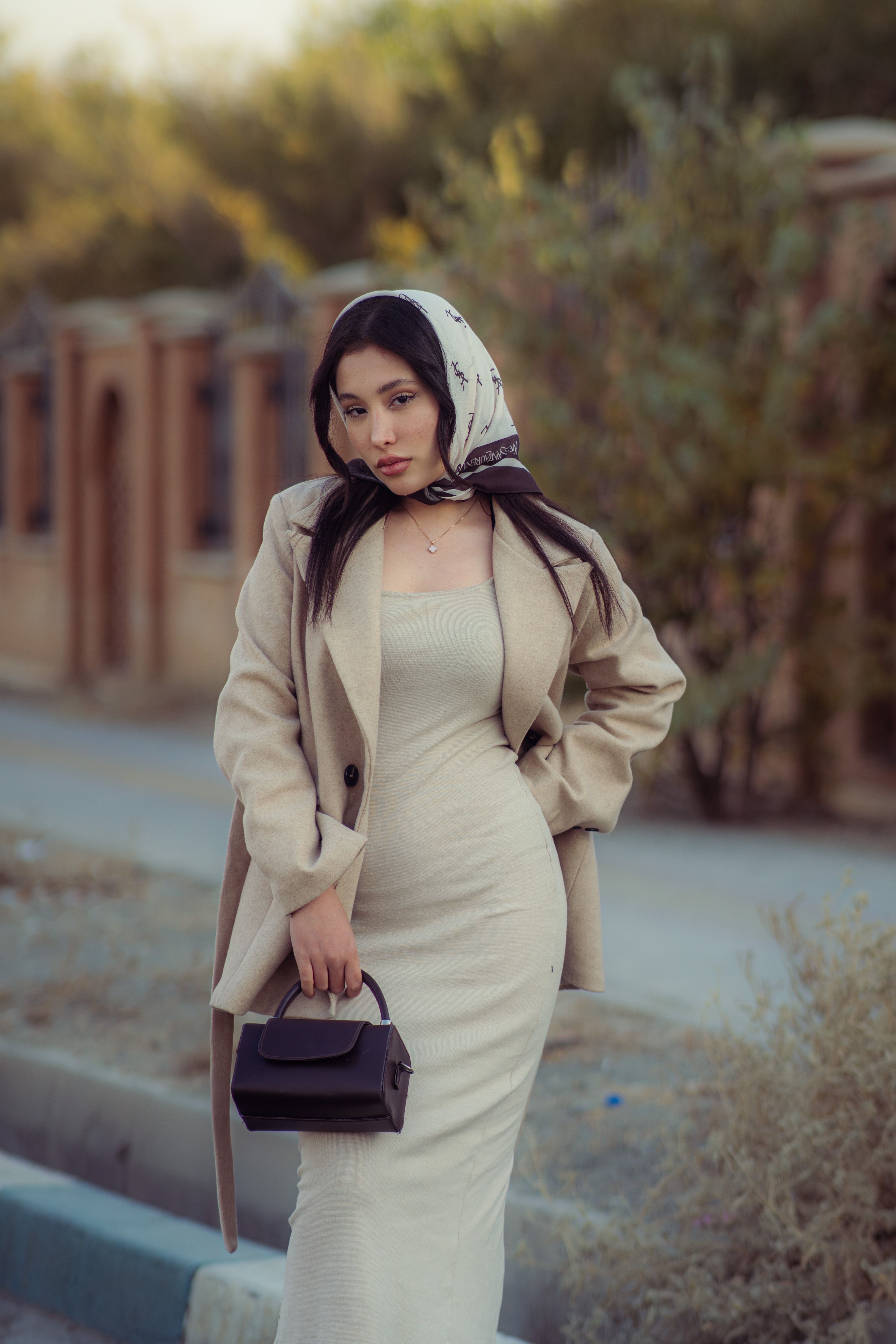 Stylish woman posing outdoors in Tehran, showcasing fashion and elegance.