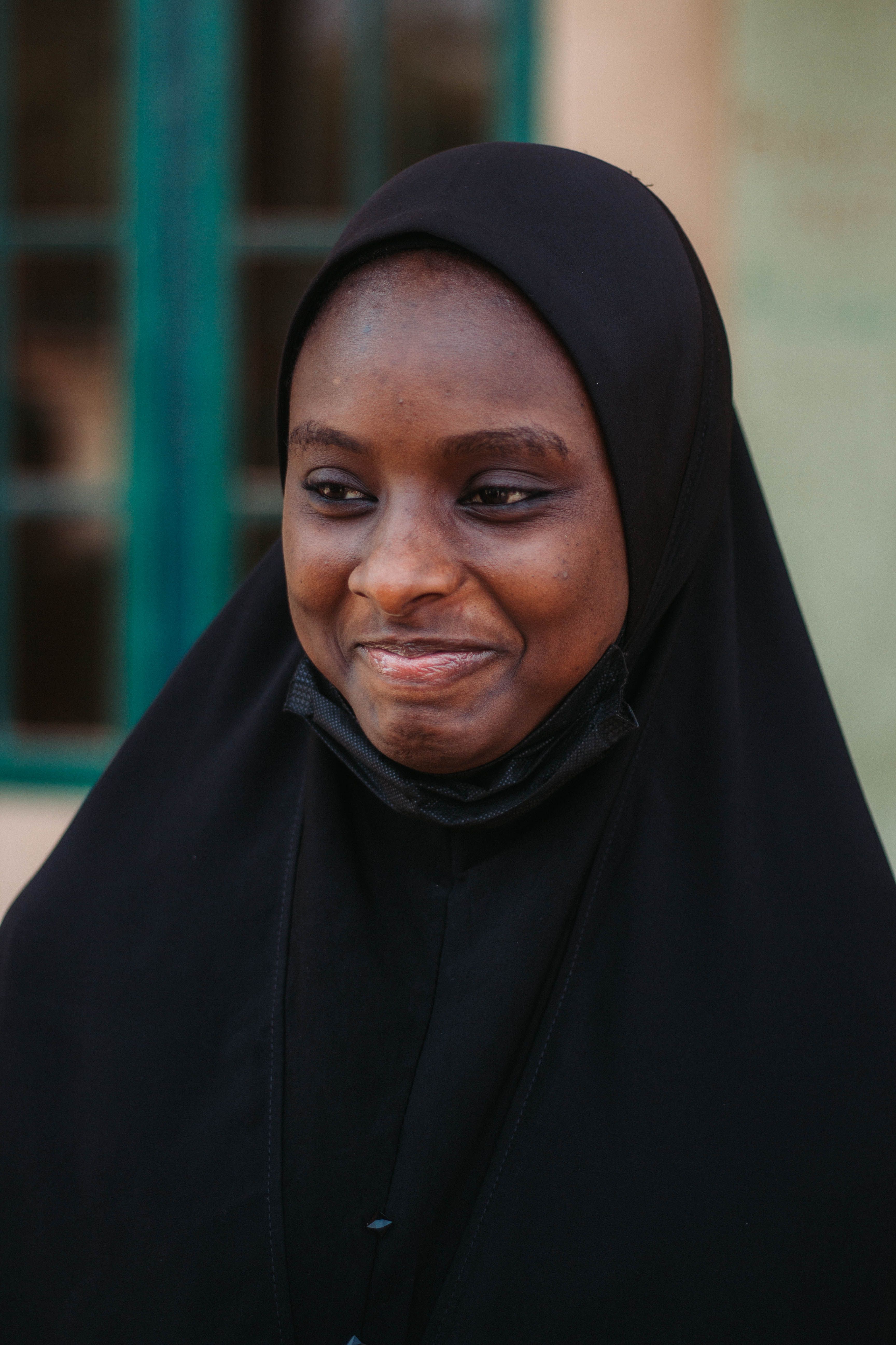 Smiling Woman in Black Hijab Outdoors · Free Stock Photo