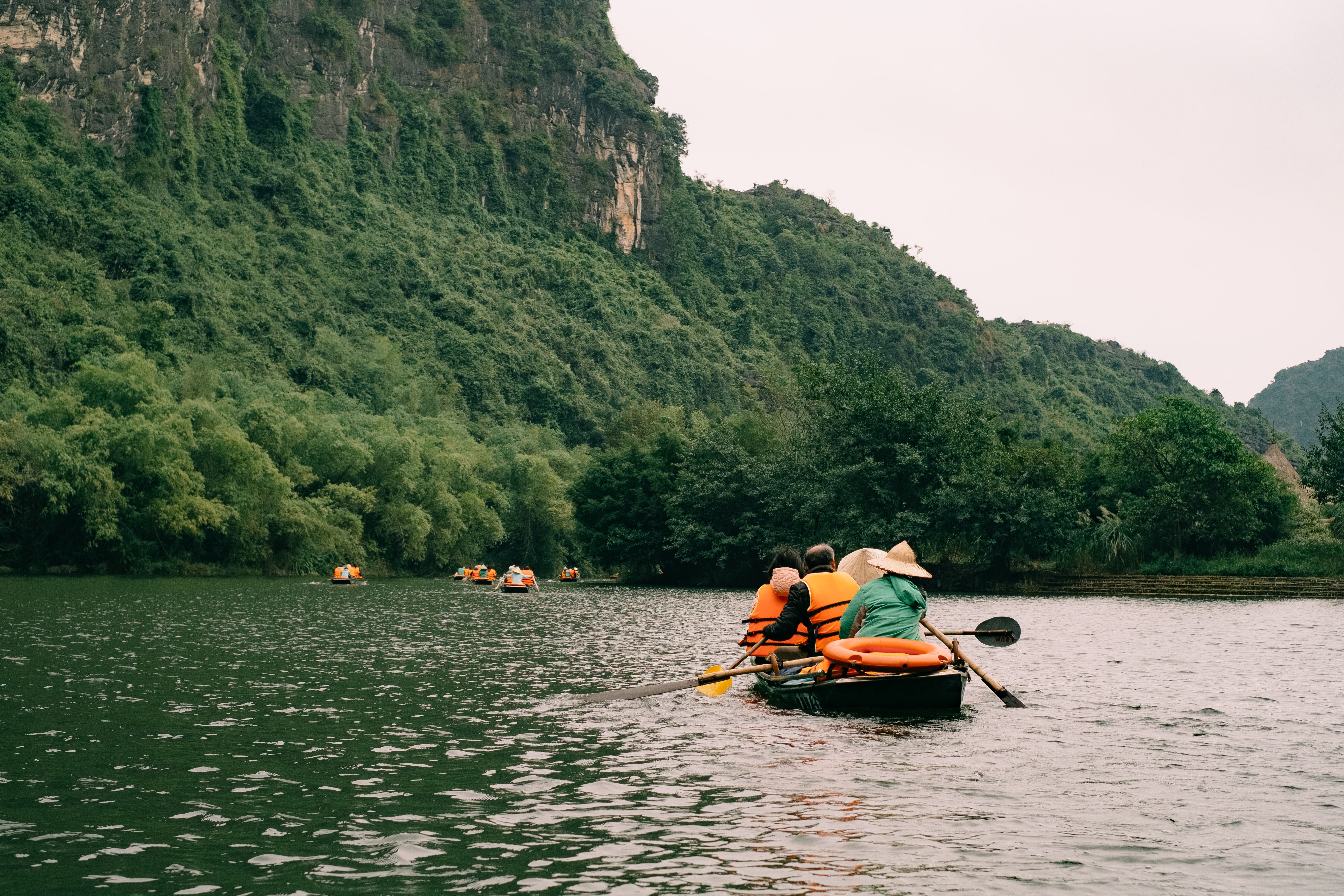 Serene River Boat Ride Through Lush Valley · Free Stock Photo