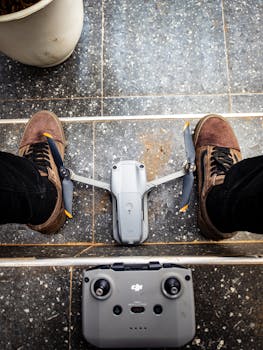 Person prepping drone on urban balcony. Ready for city flight.