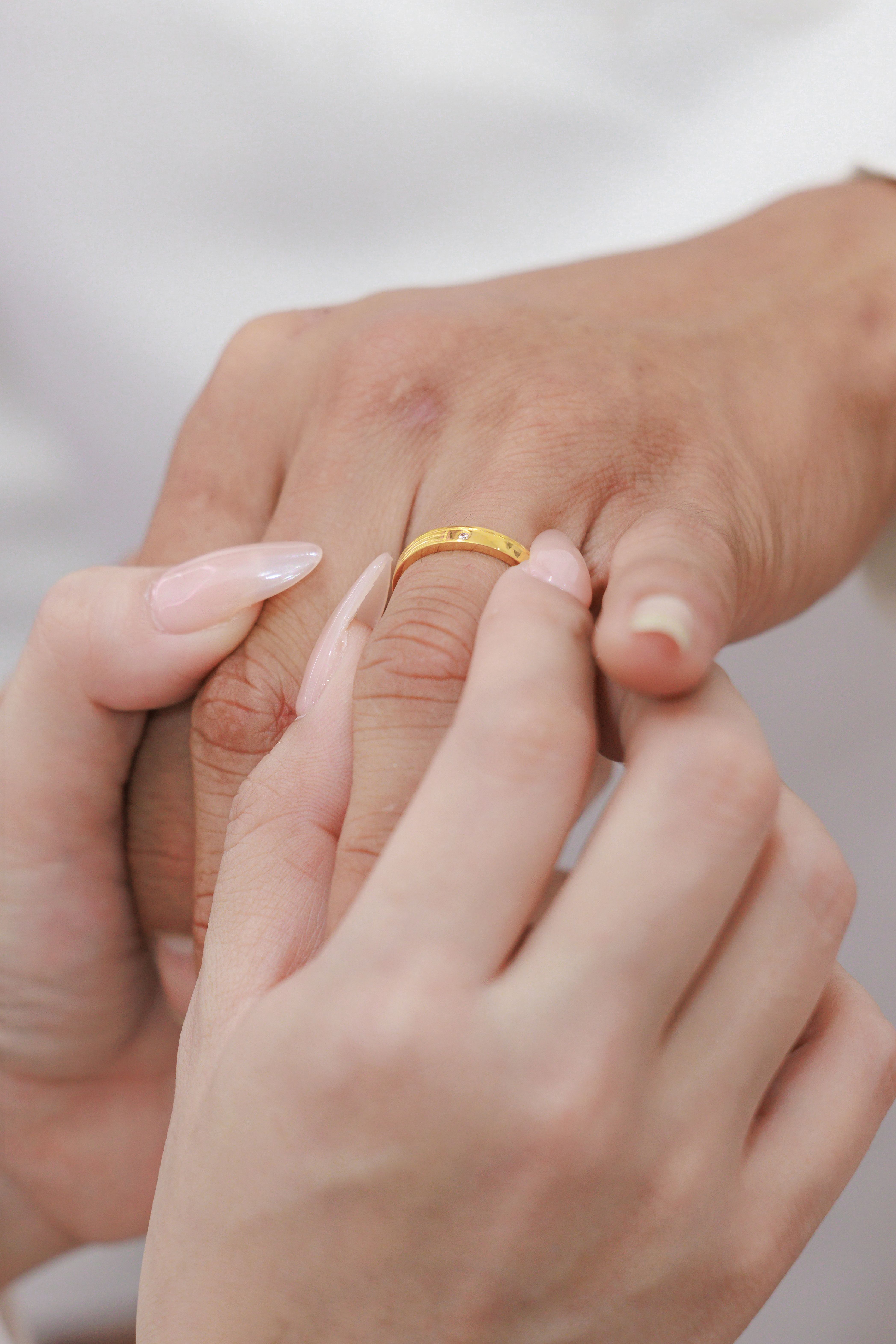 Close-Up of Hands Exchanging Wedding Rings · Free Stock Photo