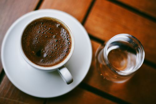 Free Enjoy a cup of traditional Turkish coffee with water at an outdoor café in İstanbul, Türkiye. Stock Photo