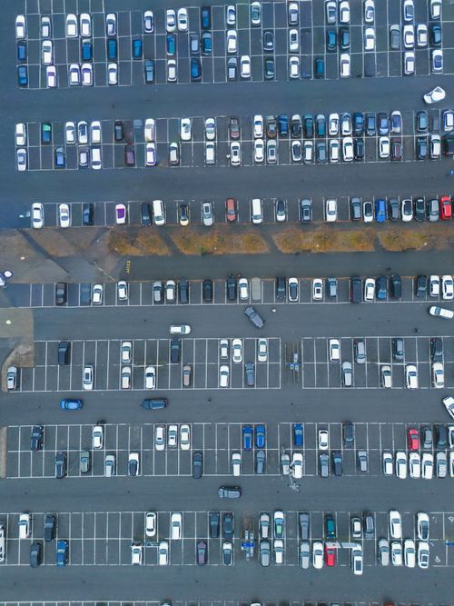 Free High-angle aerial view of a busy parking lot in Jönköping, Sweden, with cars neatly parked. Stock Photo