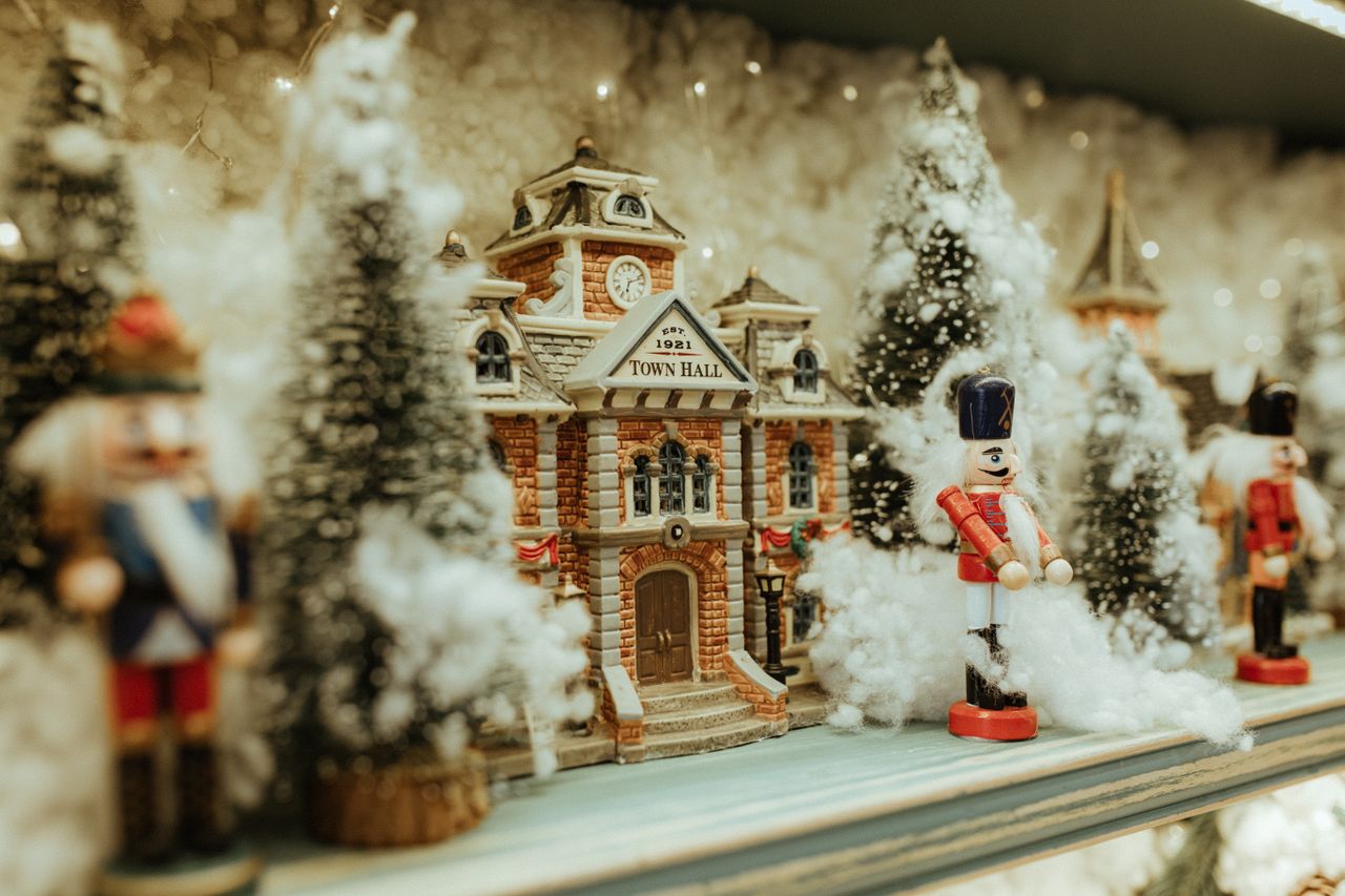 charming miniature town hall scene with nutcrackers and snowy trees ev