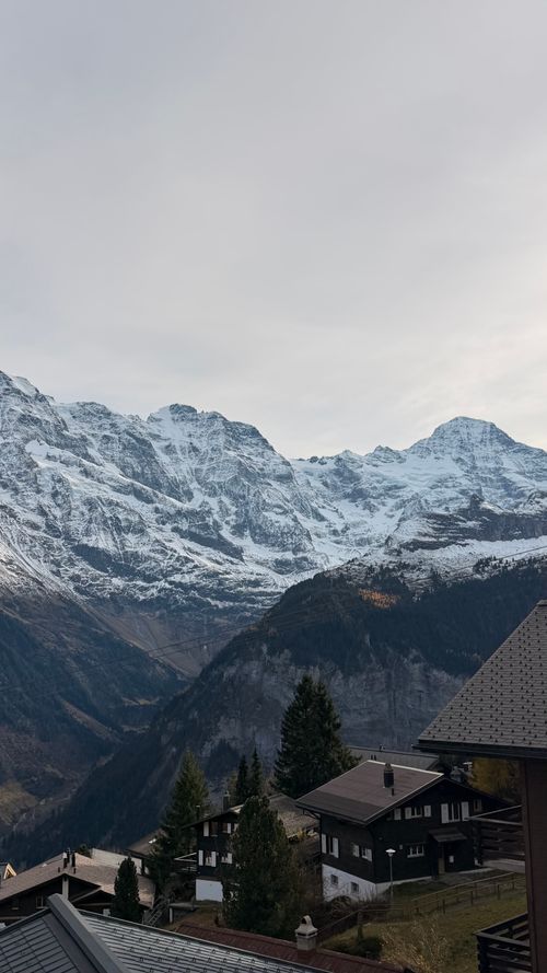 Free Beautiful vista of the Swiss Alps in Lauterbrunnen with snow-capped peaks and tranquil village setting. Stock Photo