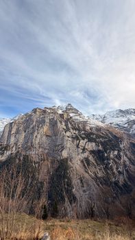 Majestic mountain landscape in Lauterbrunnen, Switzerland, capturing rugged peaks under a vast sky.