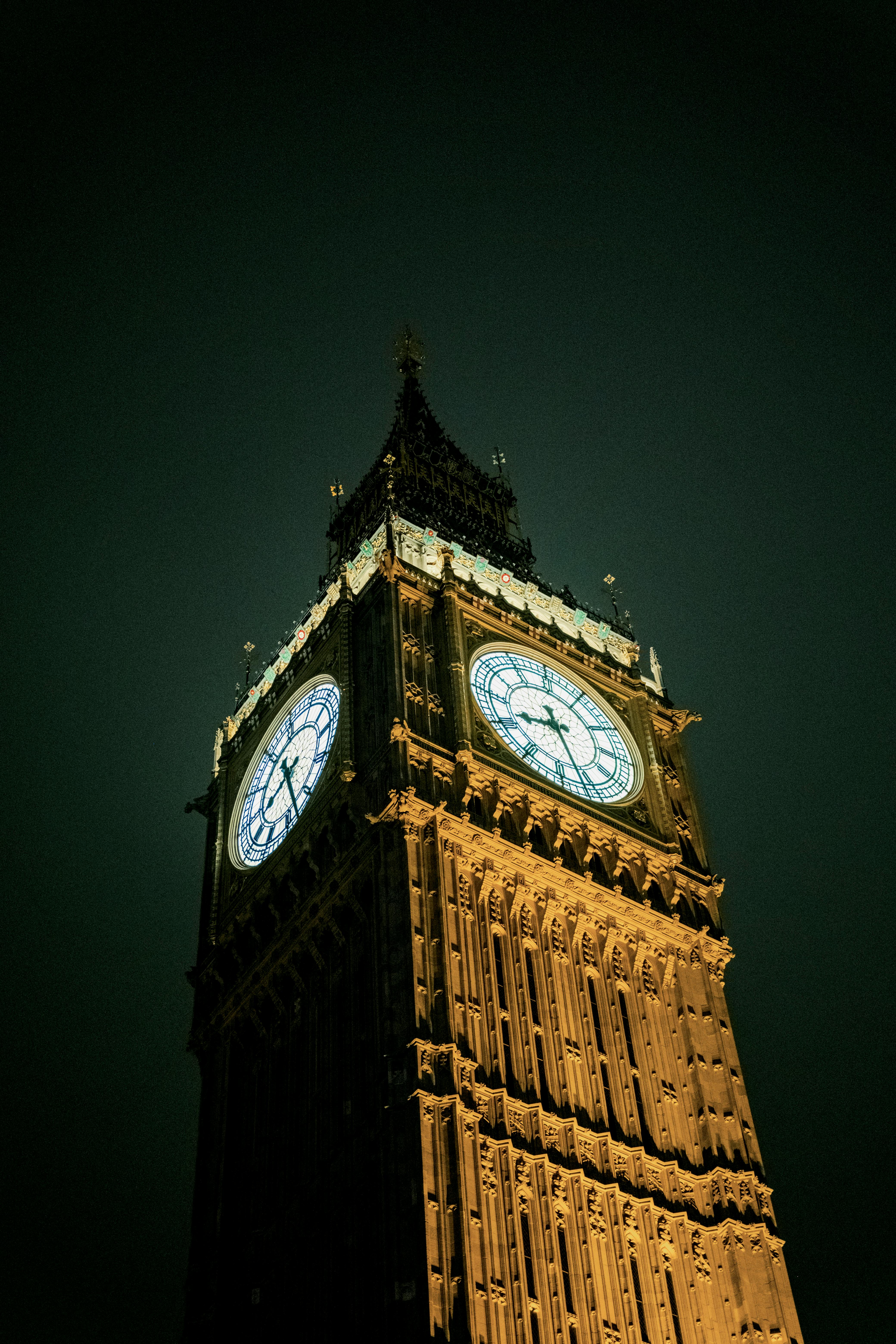 Nighttime view of Big Ben, London's iconic clock tower, illuminated against a dark sky.