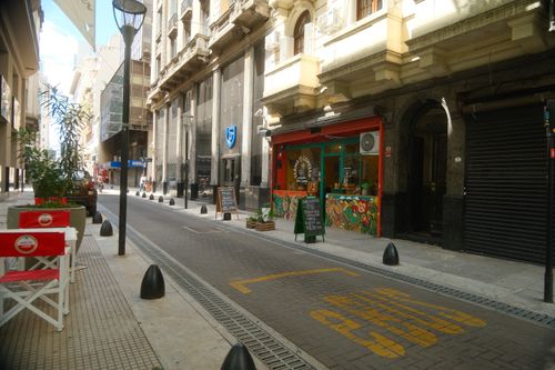 Free A vibrant street in Buenos Aires with cafes, offering a picturesque city view. Stock Photo