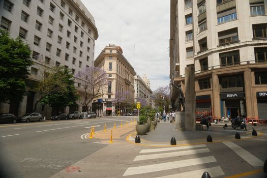 A vibrant street view in Buenos Aires, featuring classic architecture and urban life.