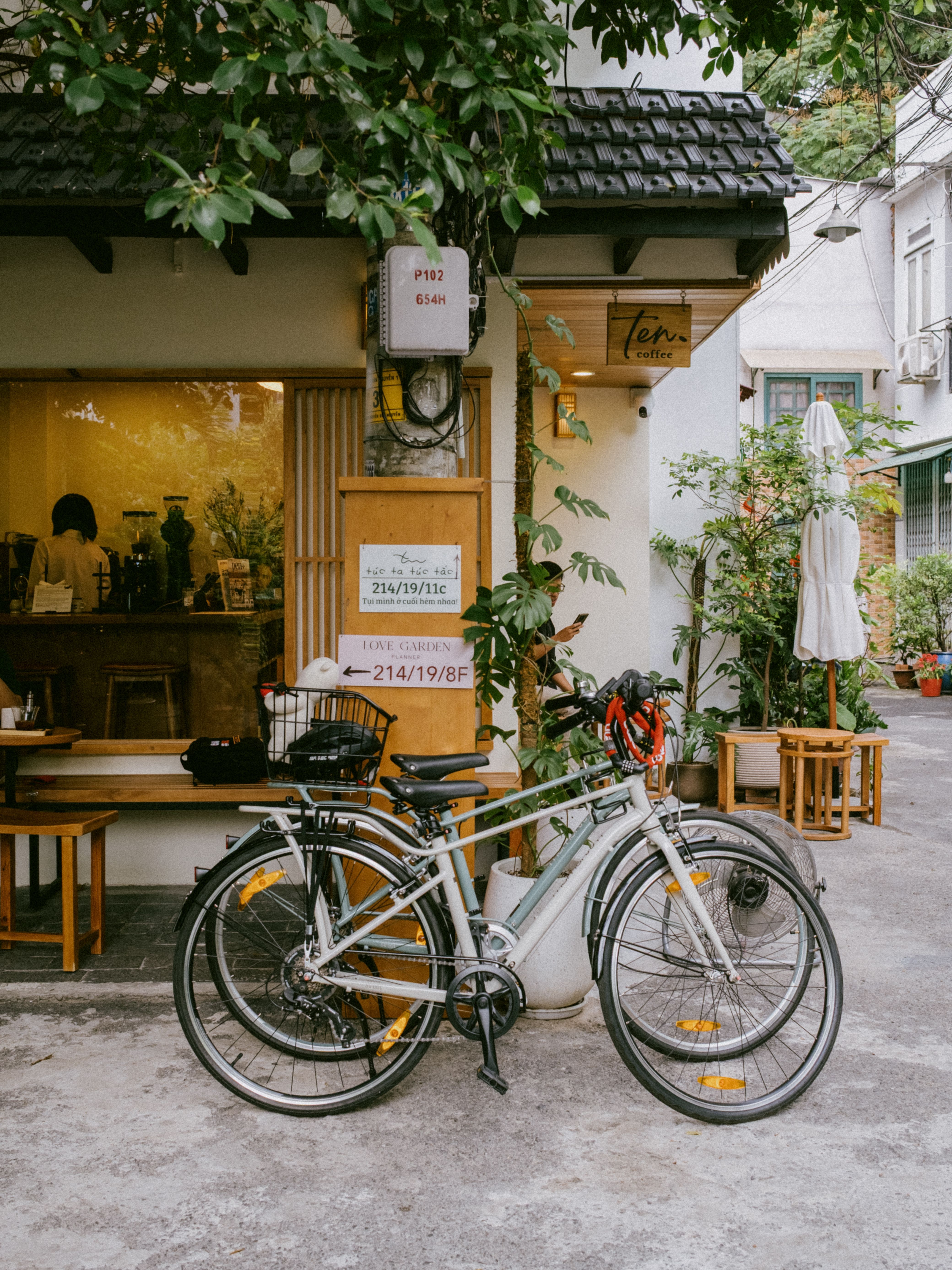 Cozy urban cafe exterior with bicycles parked outside, inviting atmosphere.