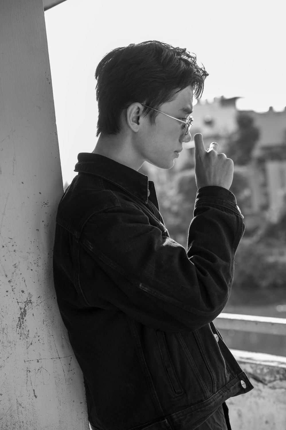 Stylish Young Man in Sunglasses Leaning Against Wall · Free Stock Photo