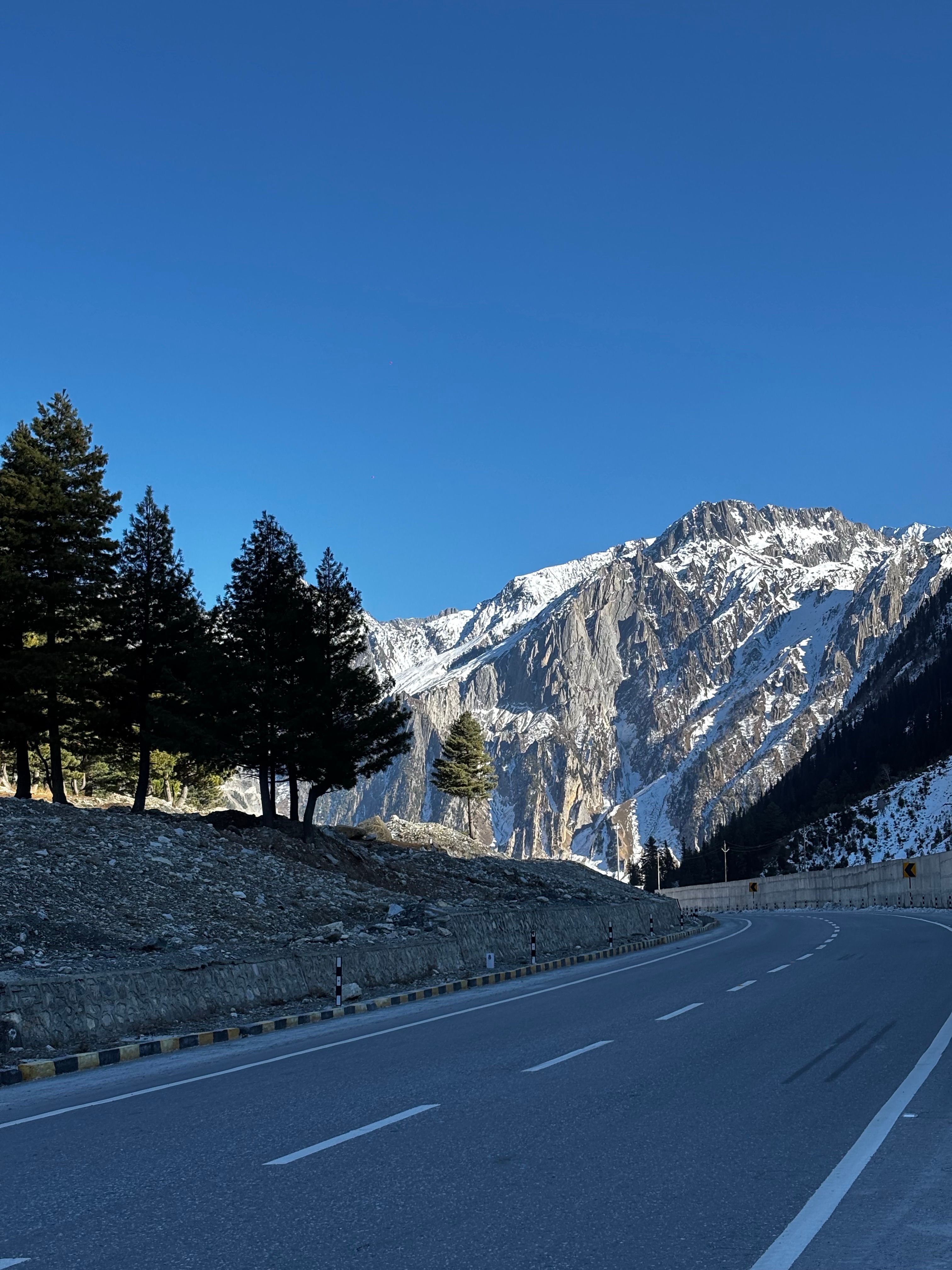 Scenic Mountain Road Under Blue Sky · Free Stock Photo