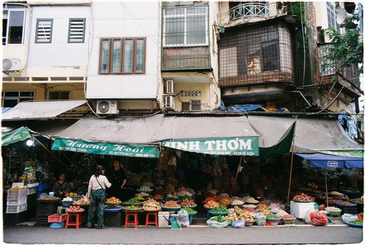 Vibrant street market in Vietnam offering fresh produce and local products.