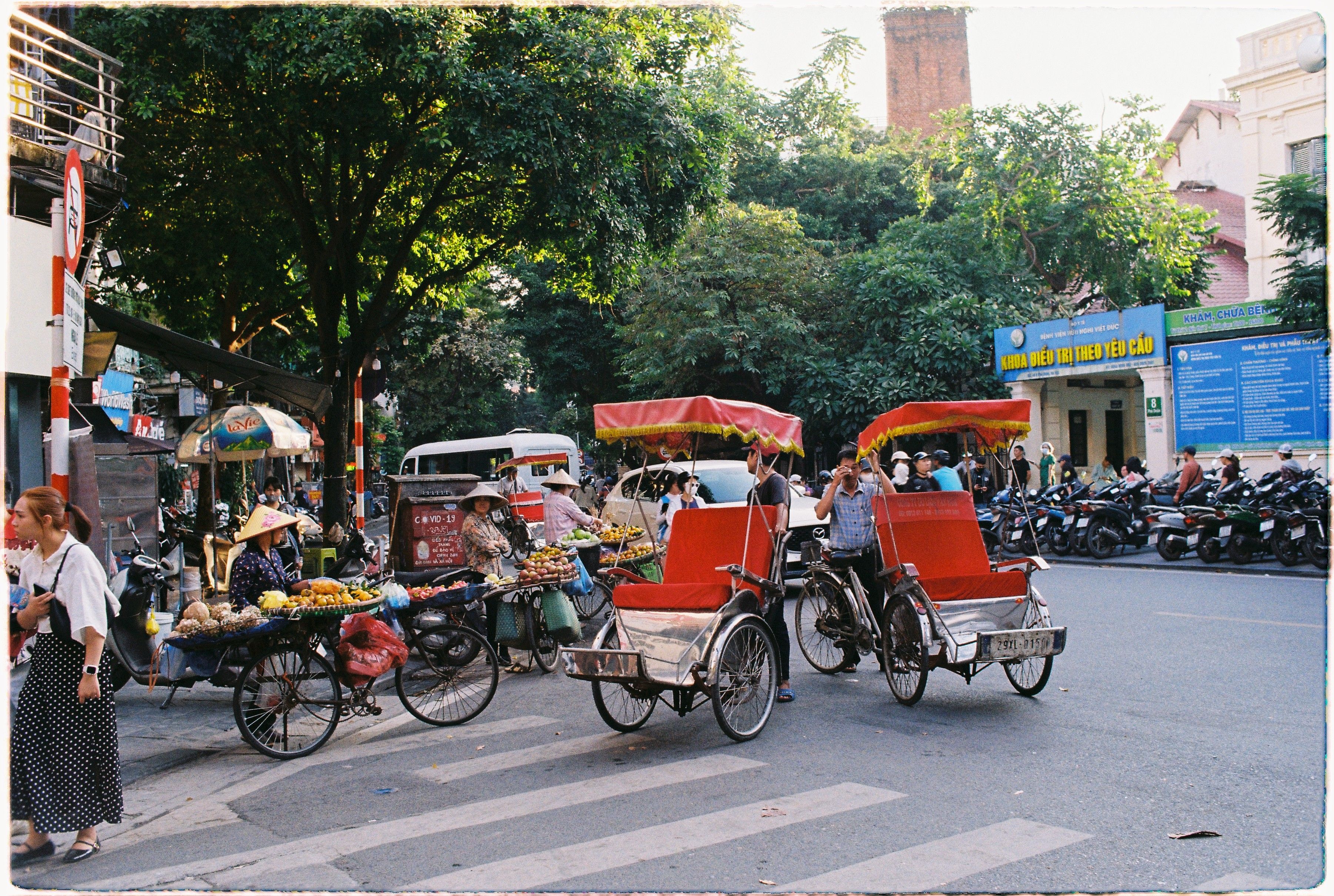 early morning street scene in Hanoi with vendors in soft mist