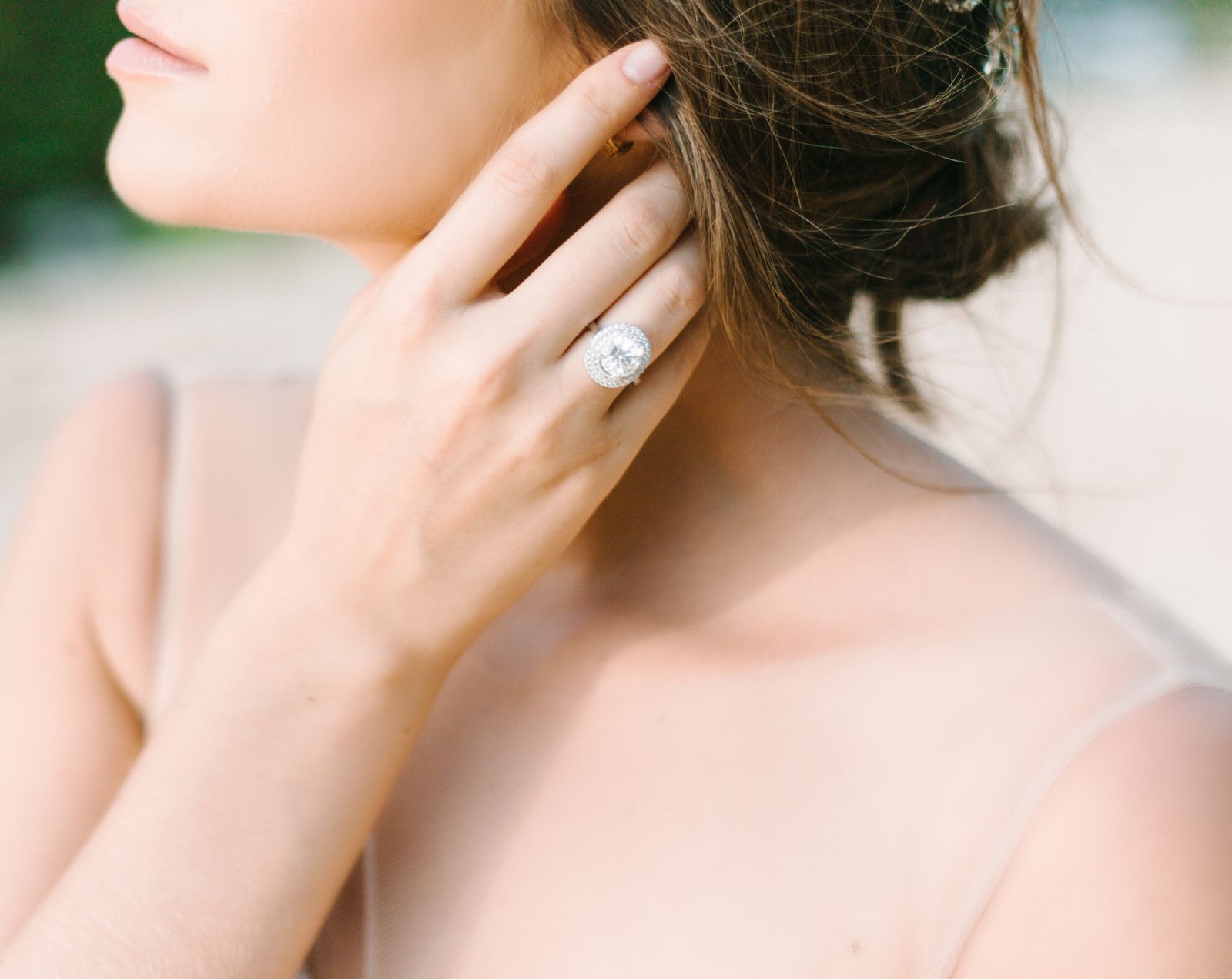 Close-up of a bride showcasing a luxurious diamond ring, exuding elegance and sophistication.