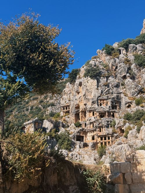 Free Explore the ancient rock-cut tombs of Myra under a clear blue sky. Stock Photo
