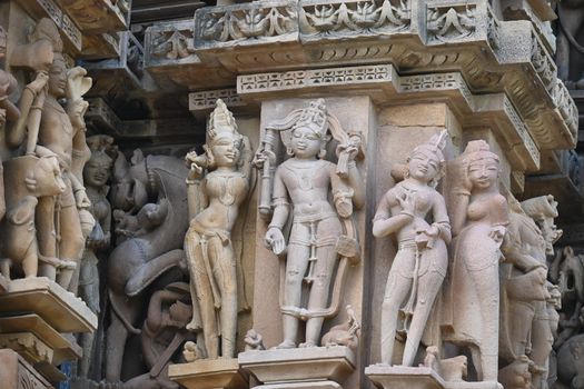 Close-up view of detailed stone carvings at a historic temple in Khajuraho, India.