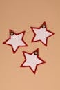 Red and White Star-Shaped Tags on Beige Background