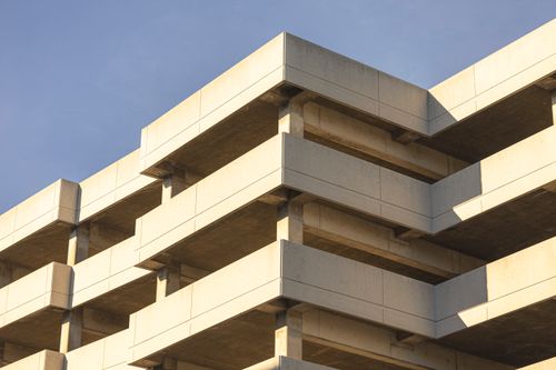 Free Concrete parking structure against clear blue sky, showcasing modern architecture. Stock Photo