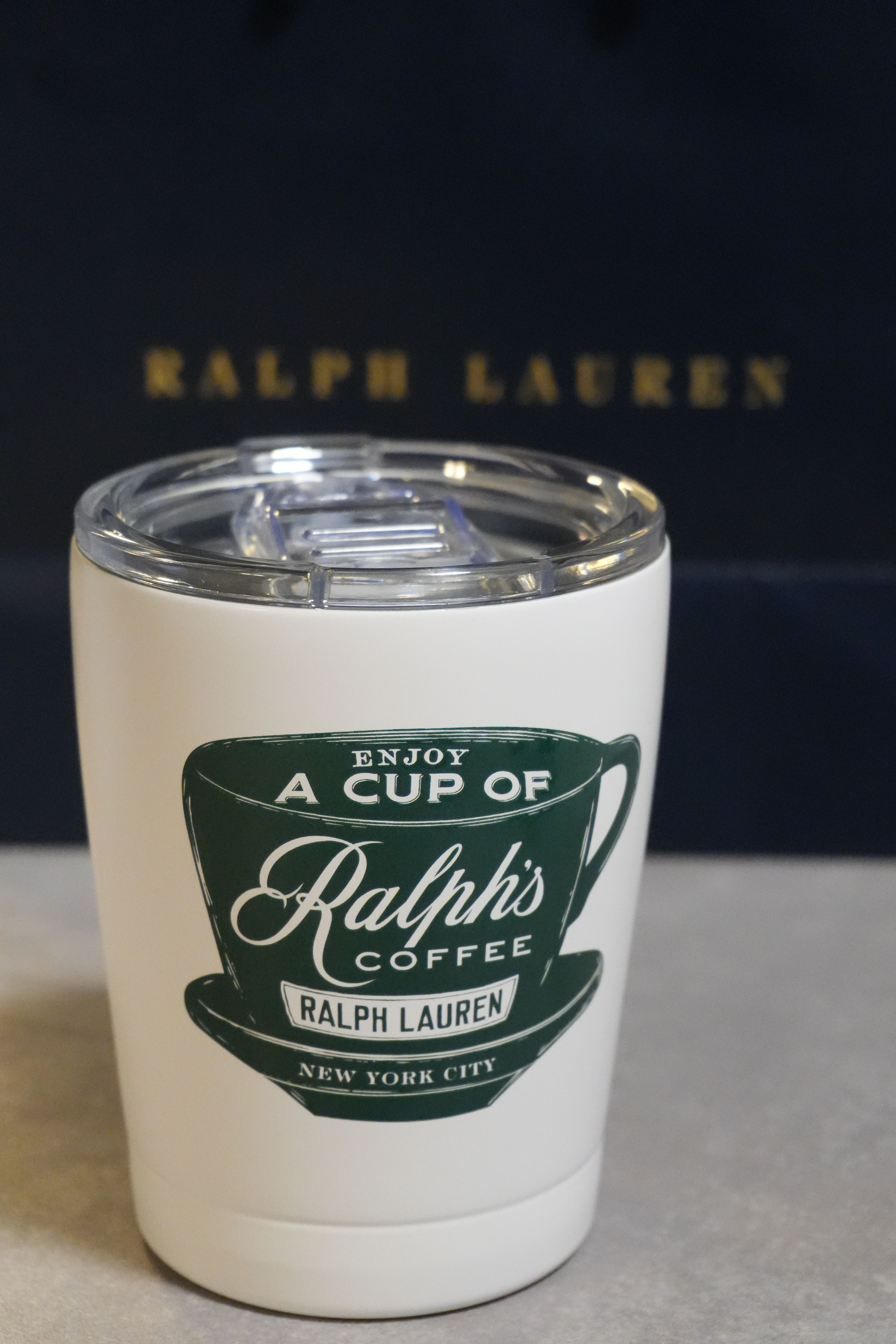 Close-up of a Ralph's Coffee tumbler against a Ralph Lauren backdrop in Berlin.