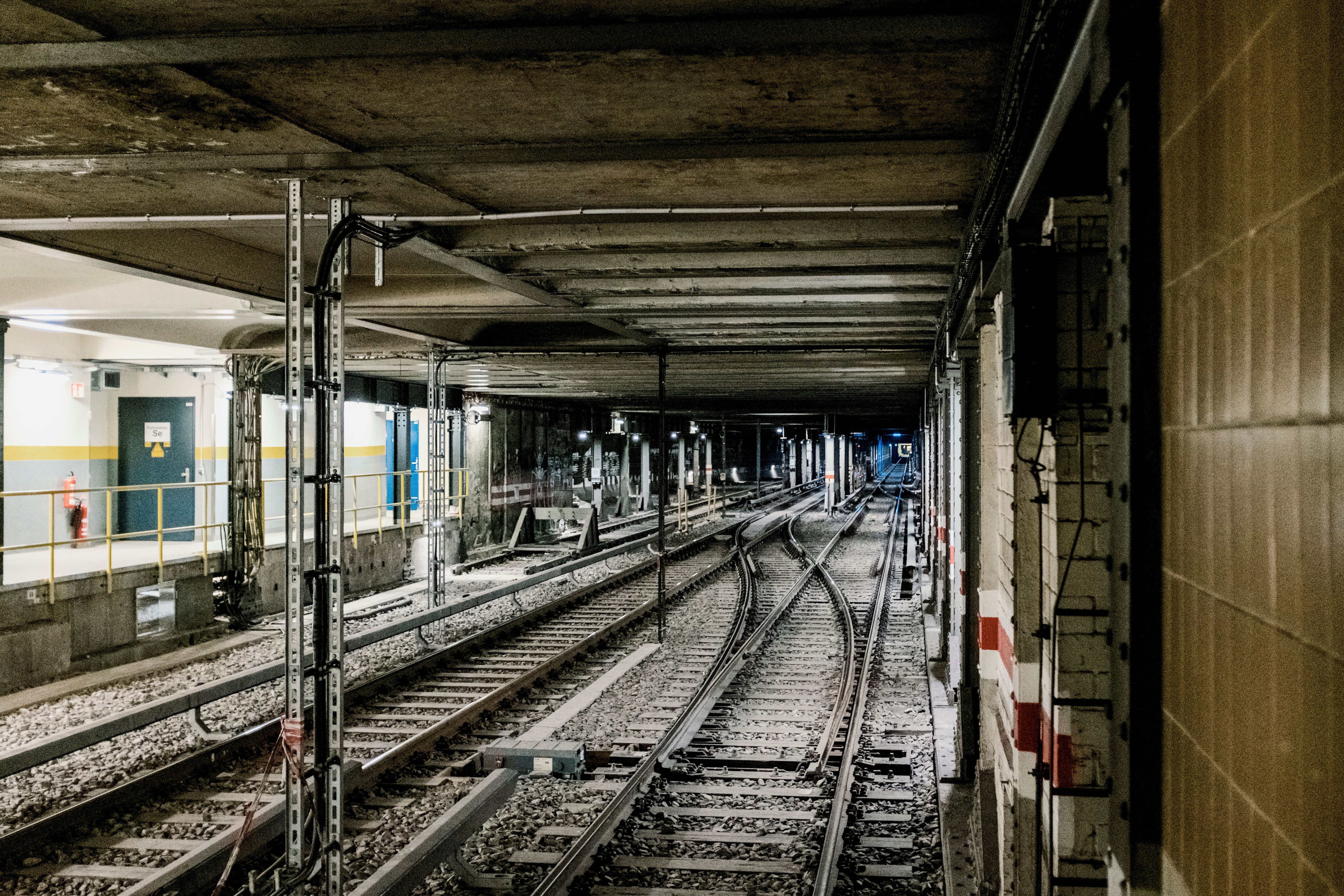 Underground railway tracks disappearing into a tunnel.
