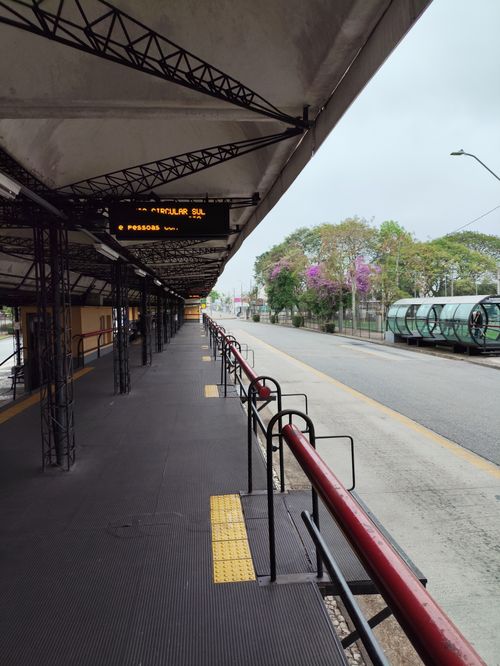 Free Empty Curitiba bus station with a circular tube design on a cloudy day. Stock Photo