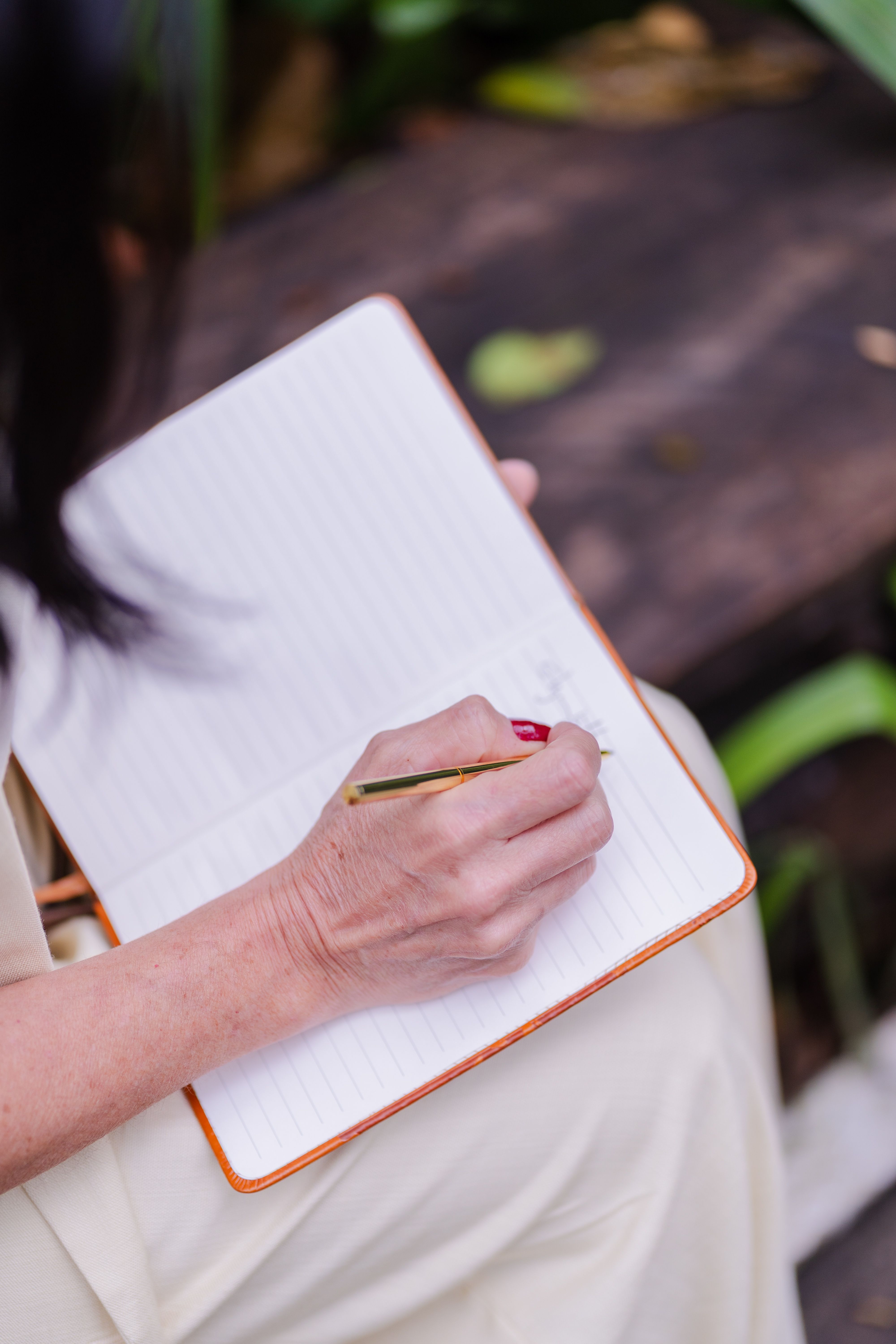 Woman Writing in Notebook Outdoors in Daylight · Free Stock Photo