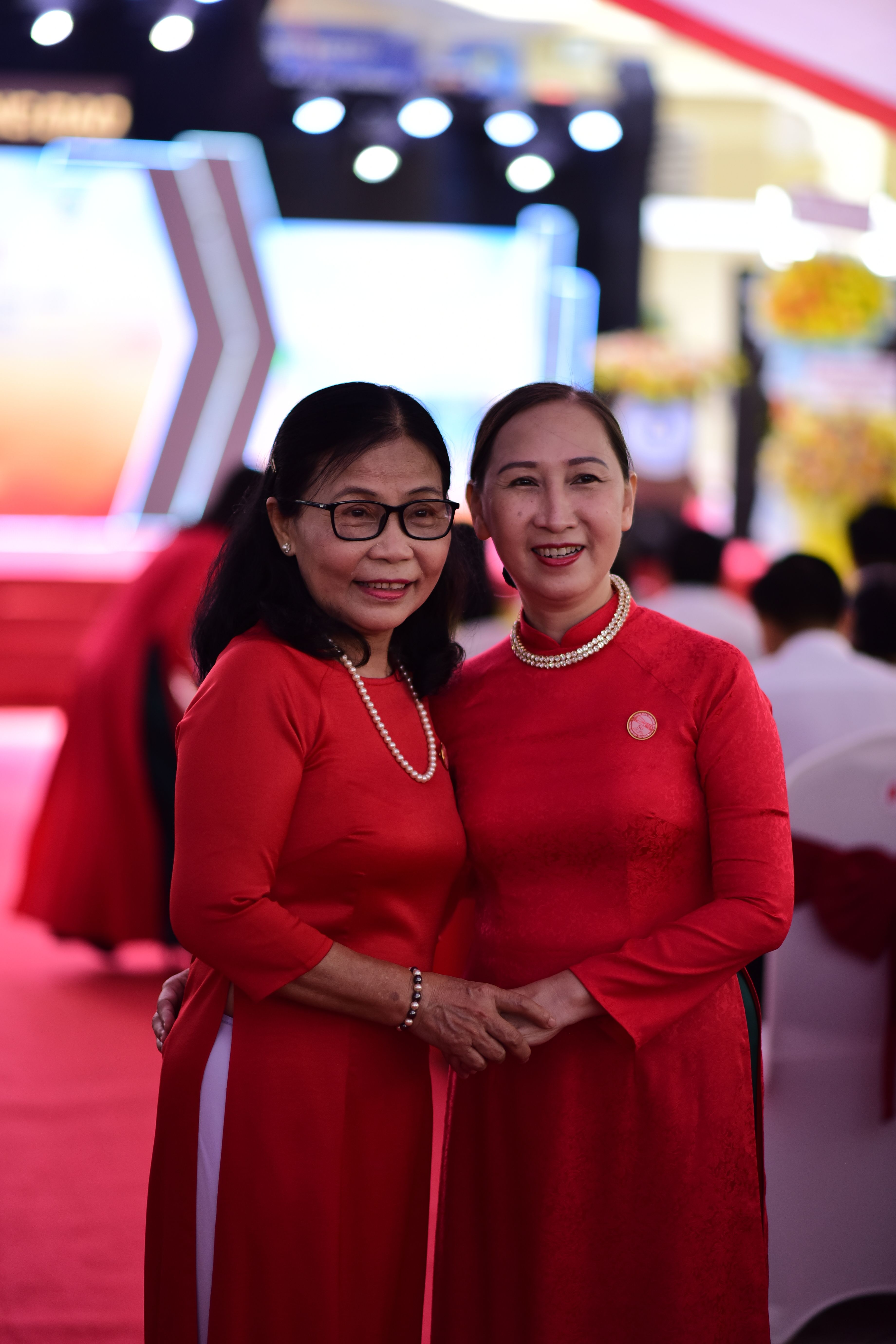 Elegant Women in Red Dresses at Formal Event · Free Stock Photo
