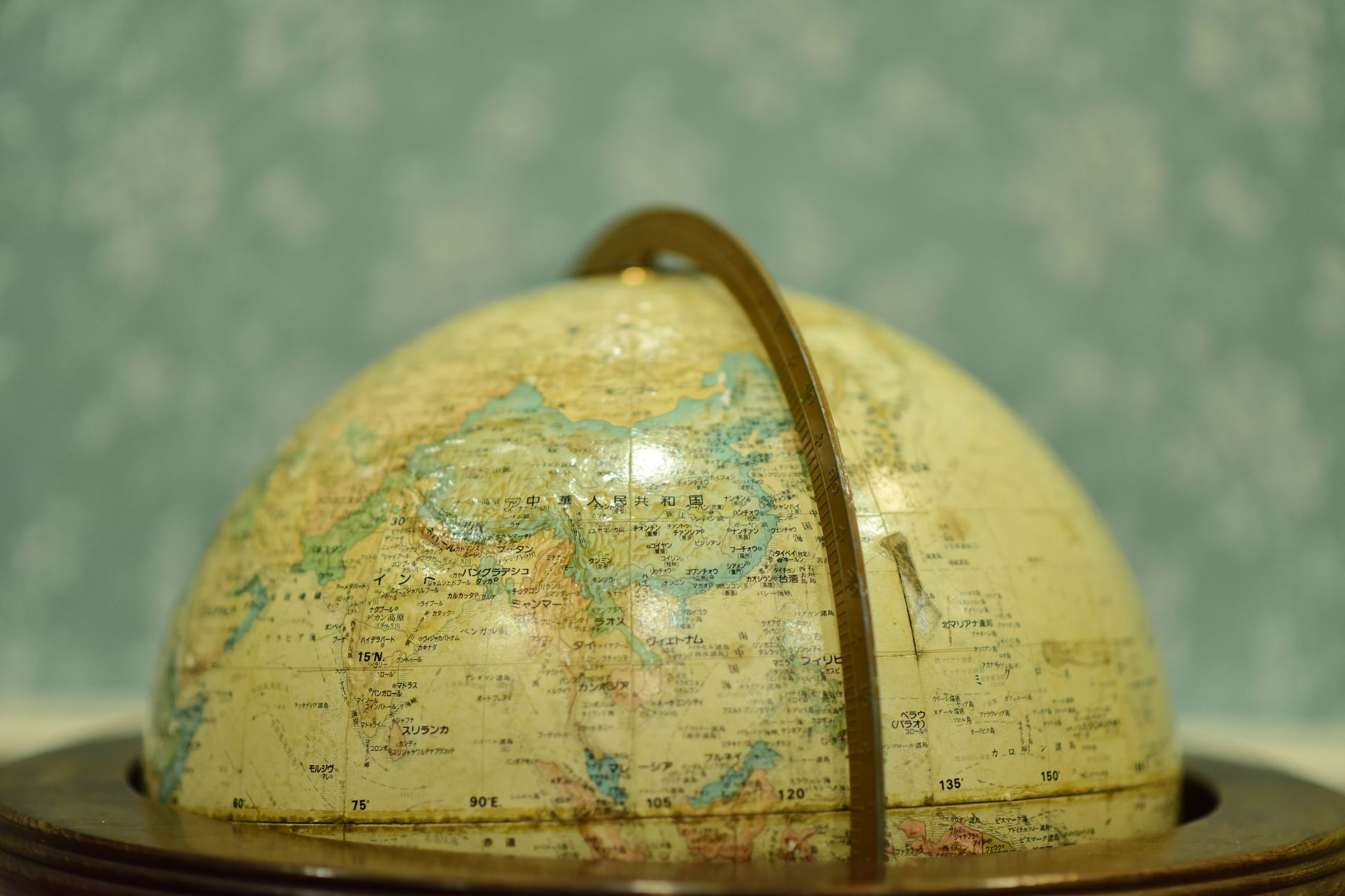Close-up of a vintage globe in soft focus, showcasing Asia and surrounding regions.