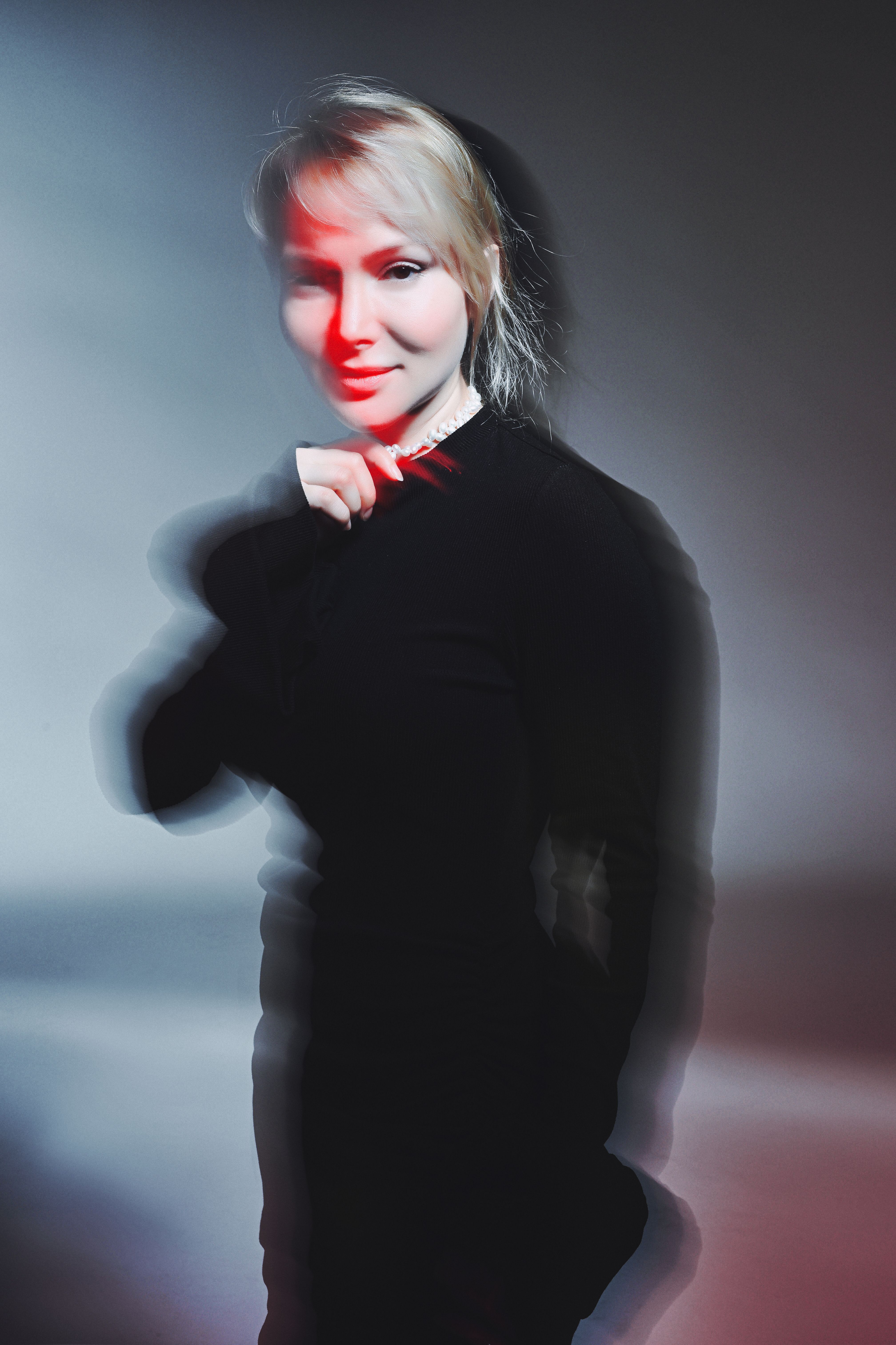 Artistic portrait of a woman with motion blur in dynamic red light.