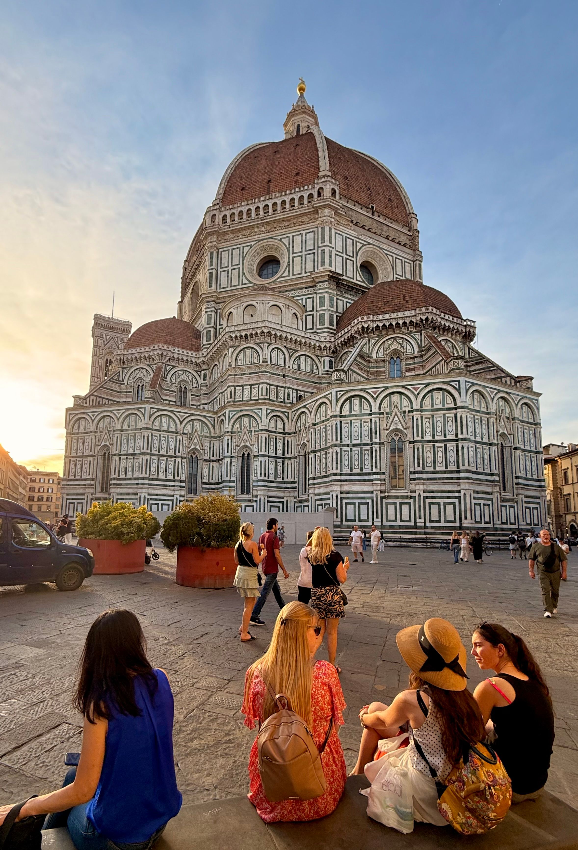 Iconic Florence Cathedral captured at sunset with tourists enjoying the view.