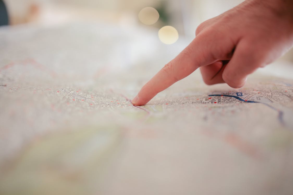 Person Pointing on White Textile