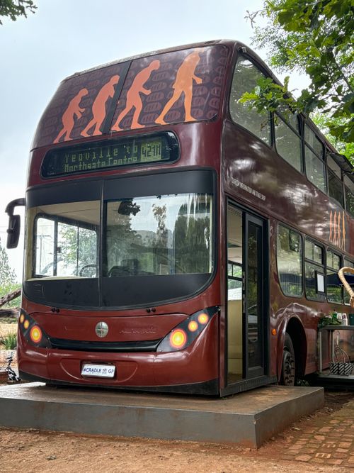 Free Double-decker bus creatively transformed into a unique outdoor cafe setting. Stock Photo