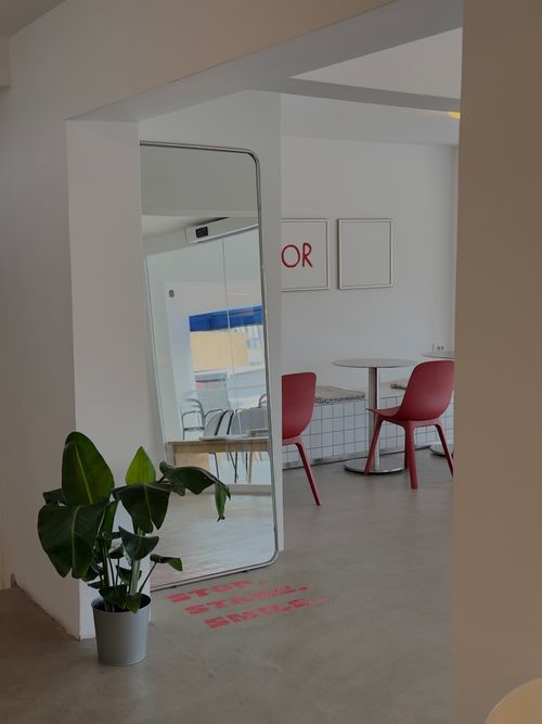 Free Modern minimalist cafe interior with red chairs and plants. Stock Photo
