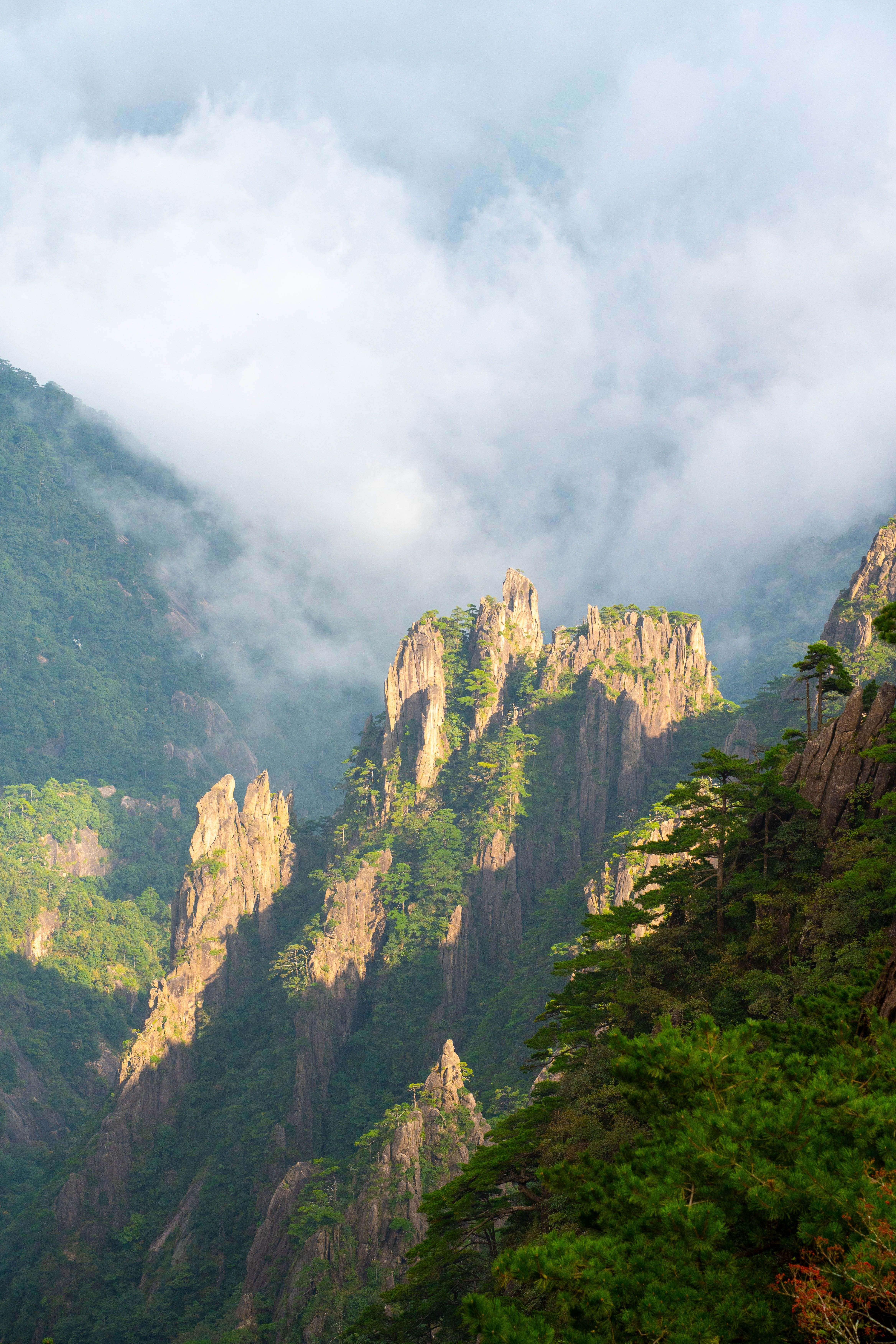 Captivating view of Huangshan peaks shrouded in mist. Perfect for travel and nature enthusiasts searching for Chinese landscapes.
