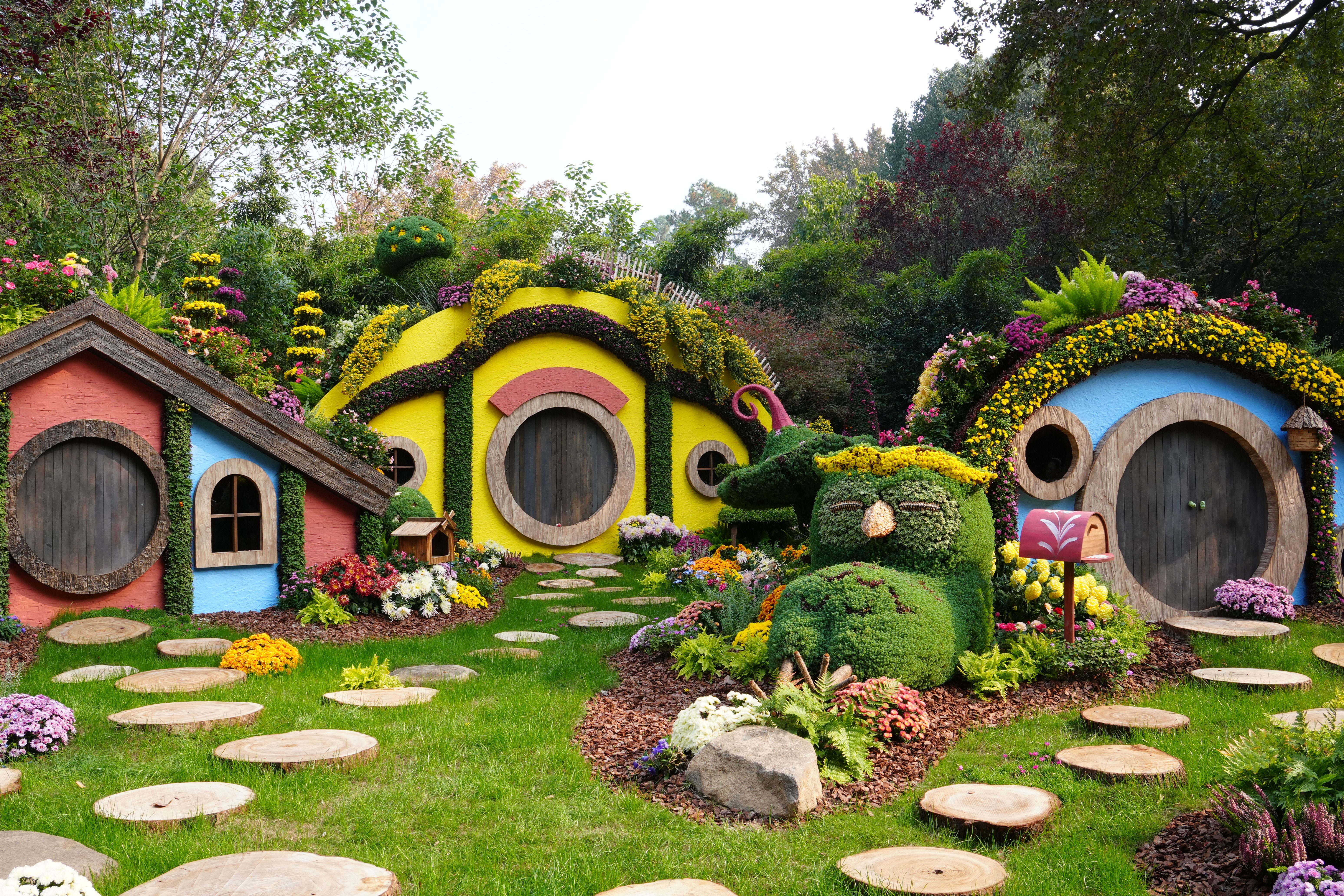 Enchanting Floral Hobbit Houses in Garden · Free Stock Photo
