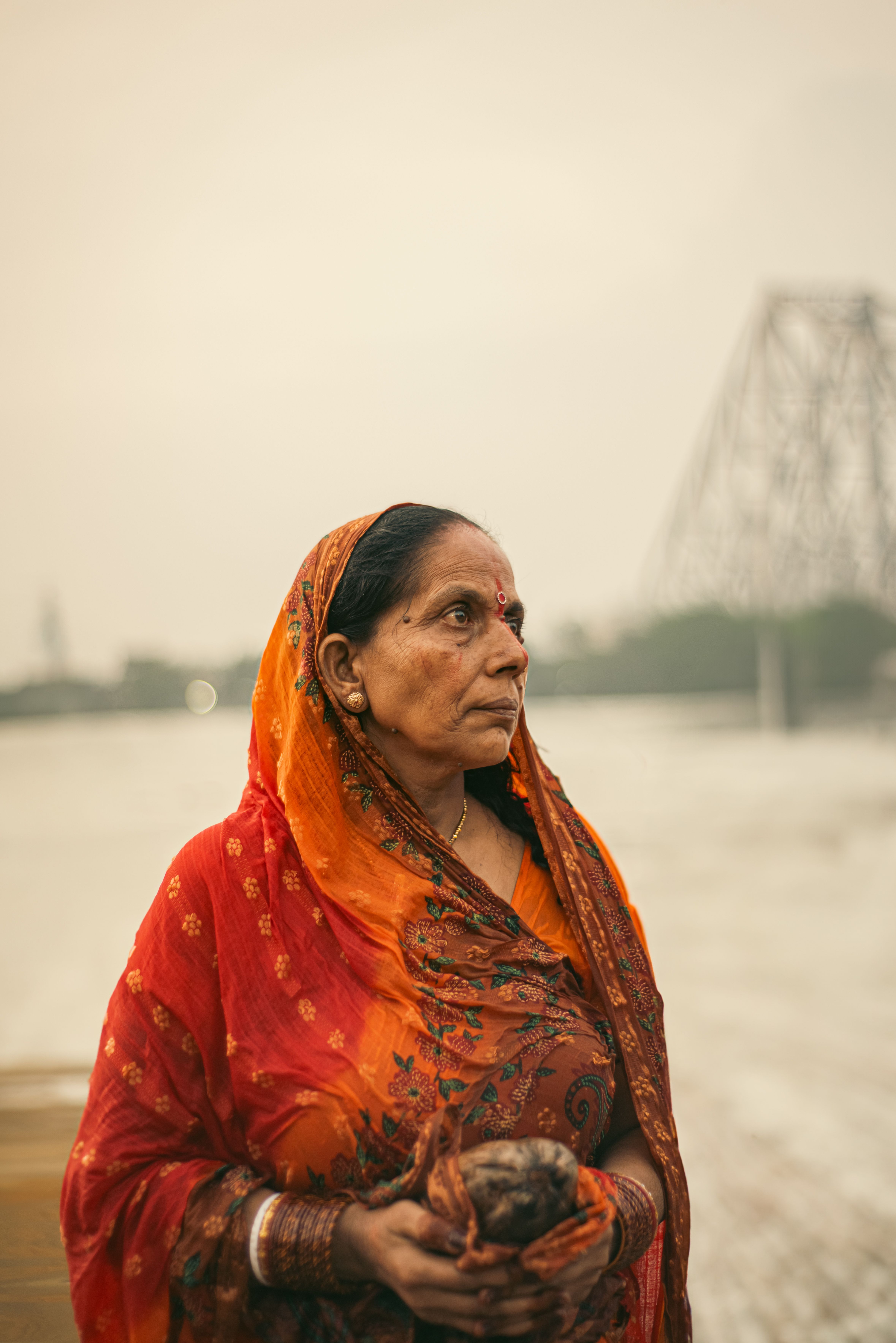 Portrait of Woman in Traditional Red Sari near River · Free Stock Photo