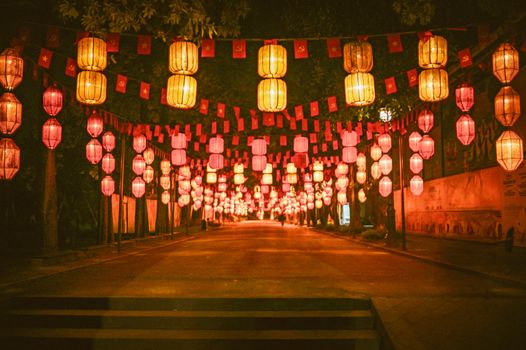 Vibrant lanterns illuminate a street at night, creating a festive ambiance.