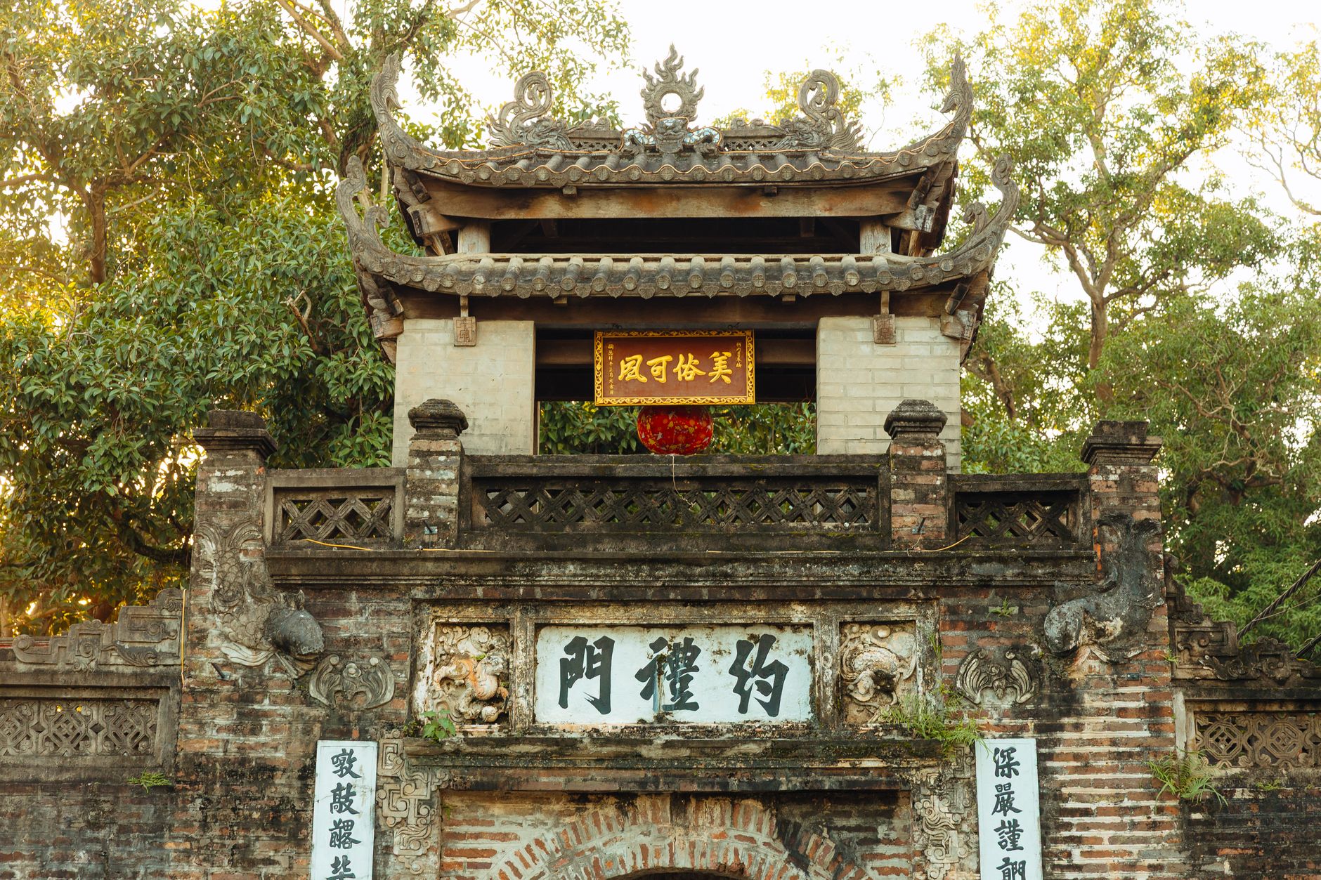 A historic Asian temple entrance with intricate architecture and Chinese inscriptions.