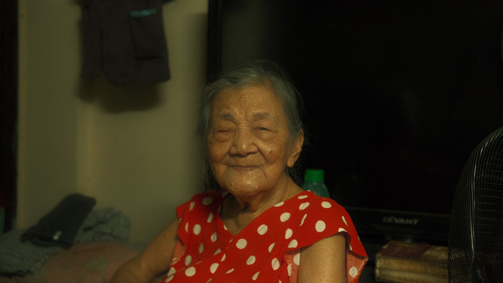 An older woman smiling in the comfort of home