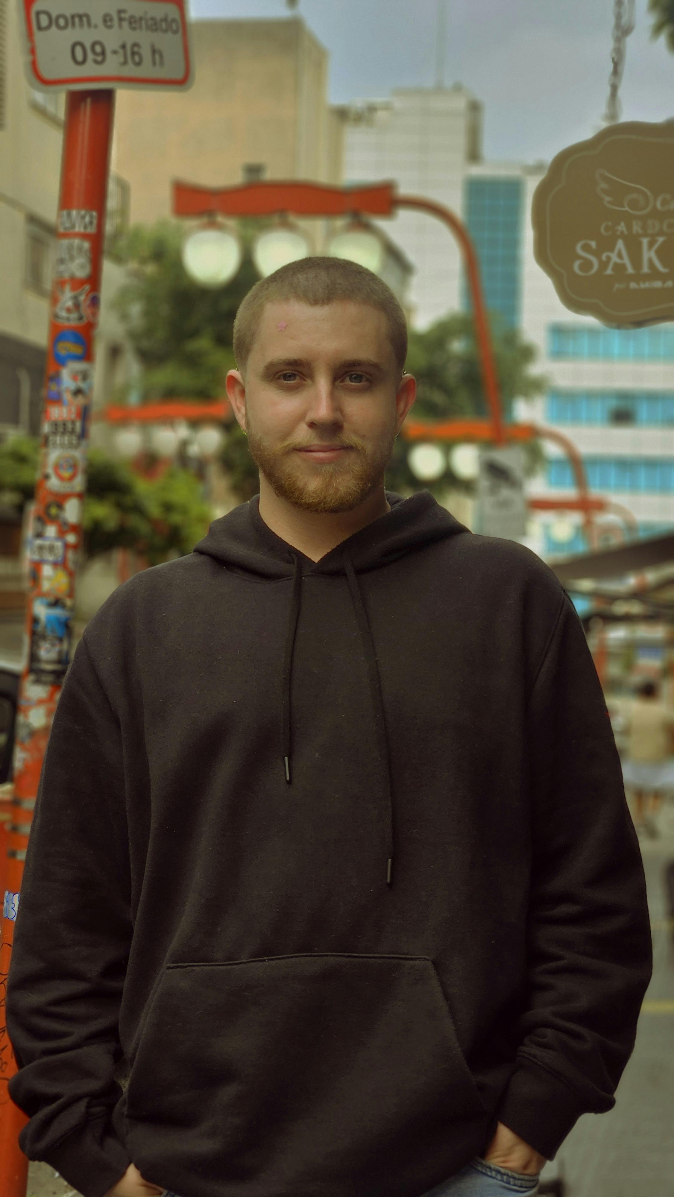 Casual portrait of a man in São Paulo's vibrant Liberdade district showcasing urban culture.