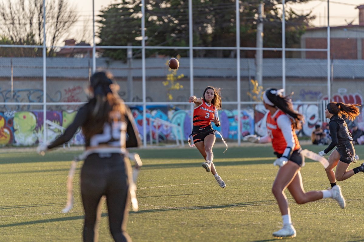 Female players competing in flag football
