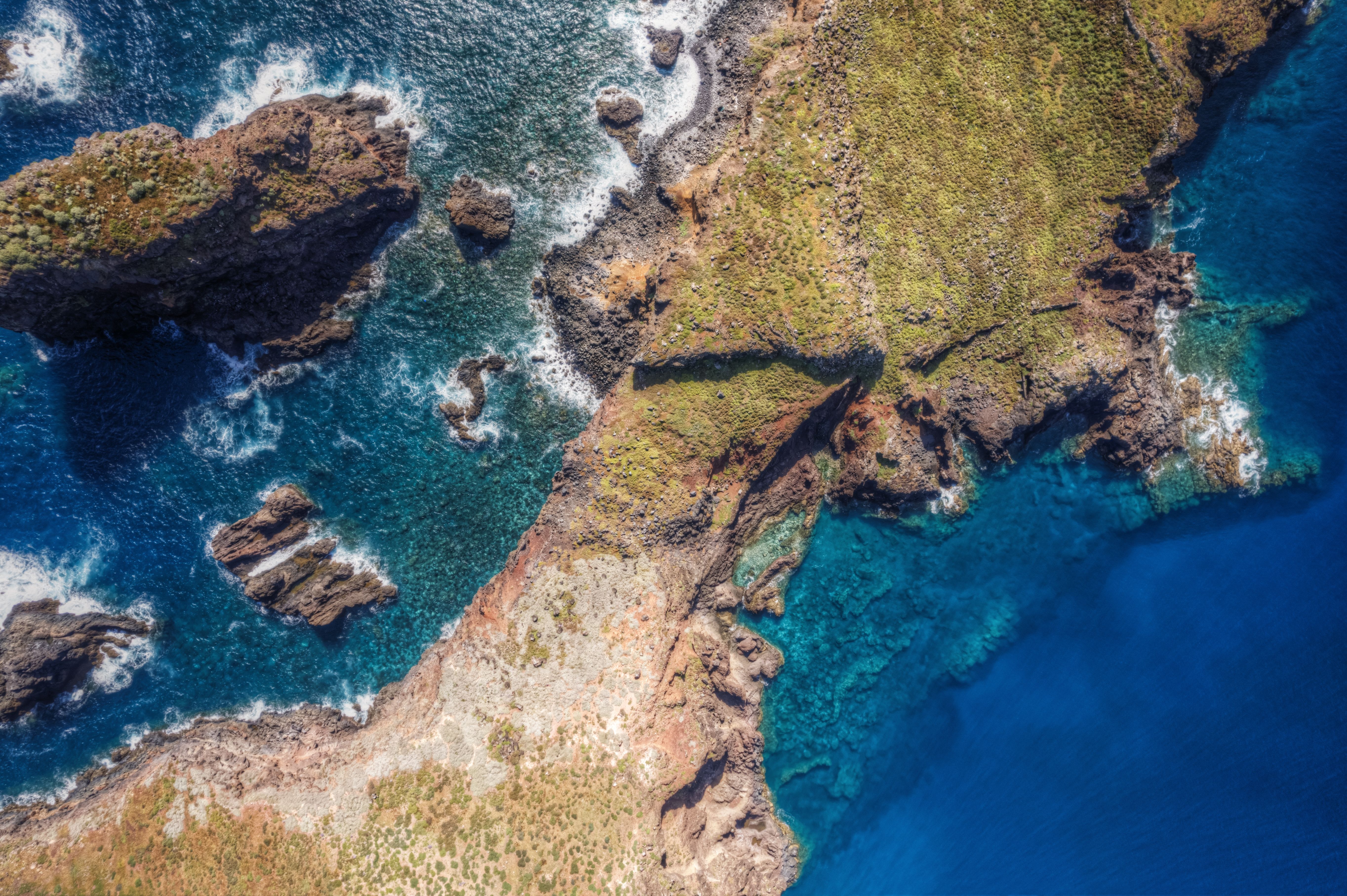 Amazing Hana Rainforest Scenic Helicopter Tour Review: Maui's Most Spectacular East Side Adventure Review 2026 - Stunning aerial view of Madeira's rocky coastline, showcasing dramatic cliffs and vibrant blue waters.