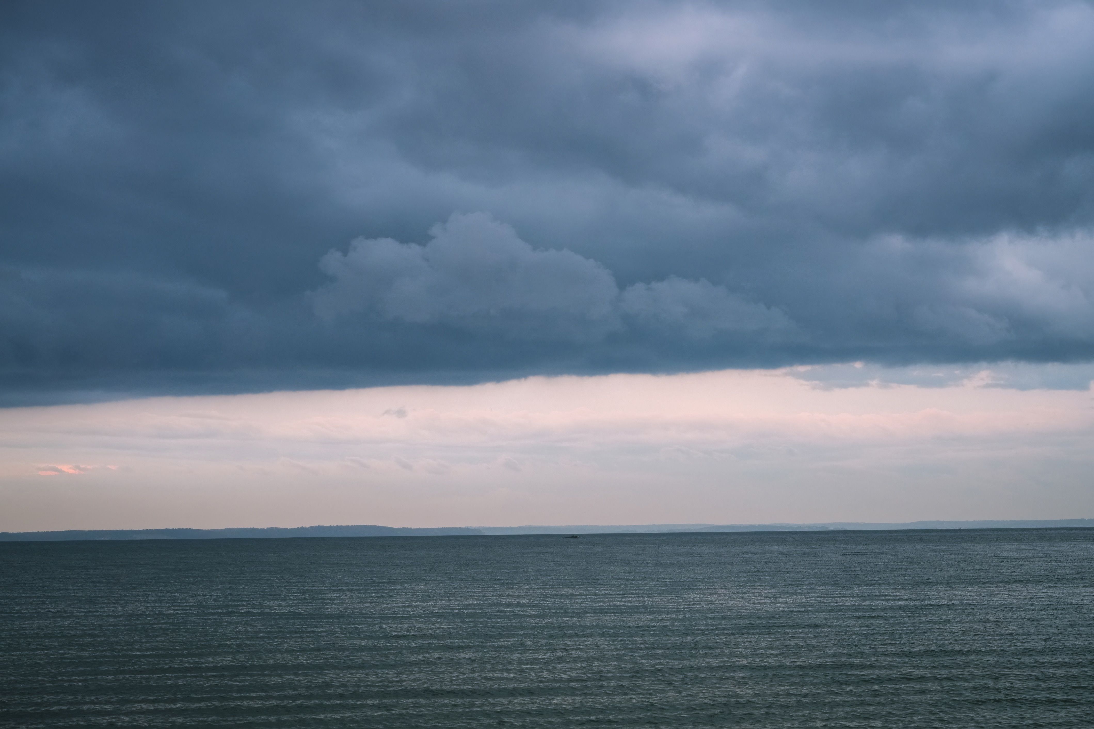Dramatic Cloudy Sky Over Calm Ocean View · Free Stock Photo