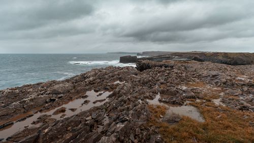 Free Stunning view of rocky sea cliffs in Ireland under stormy clouds, showcasing nature's raw beauty. Stock Photo