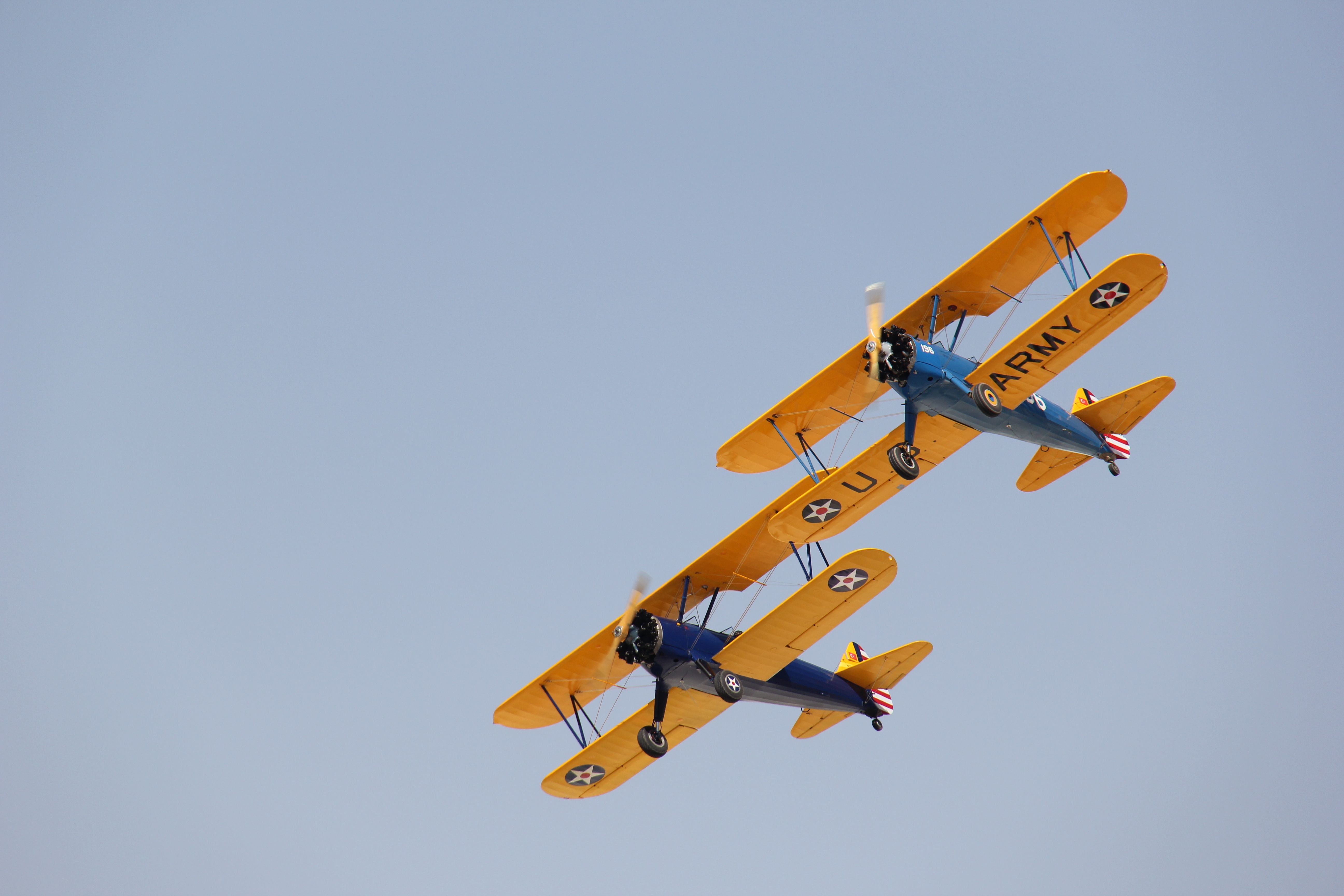 Two Vintage Biplanes Flying in Formation · Free Stock Photo