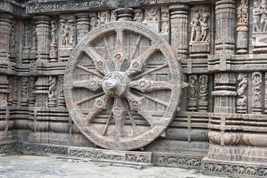 Explore the detailed stone carvings of a wheel at Konark Sun Temple in Odisha, India, showcasing ancient Indian architecture.