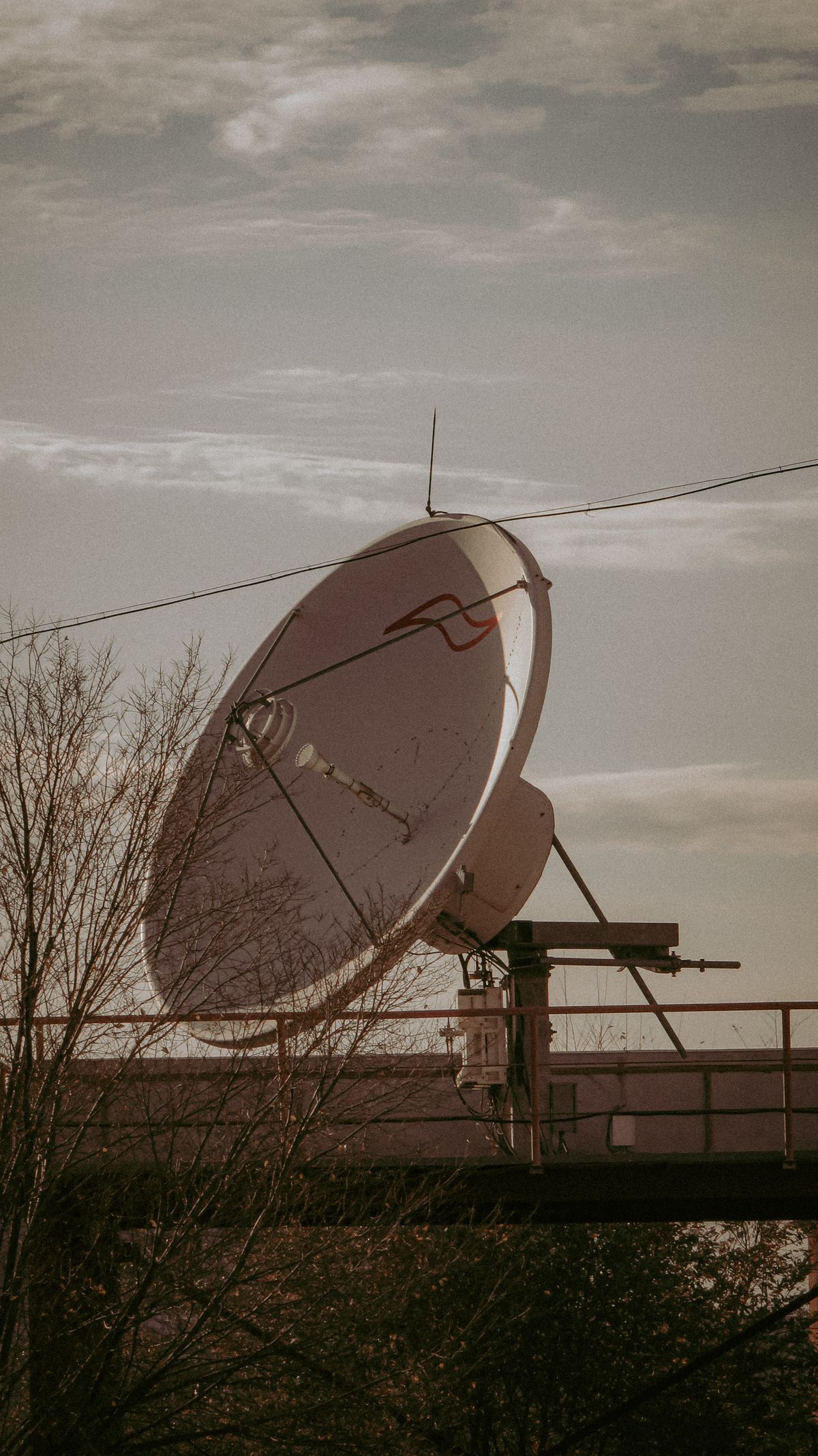 Satellite internet dish mounted against the sky, the hardware behind a Starlink reselling business