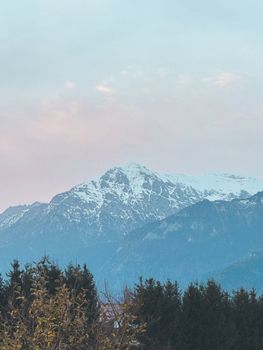 Stunning view of a snow-capped mountain amidst a serene dawn sky.